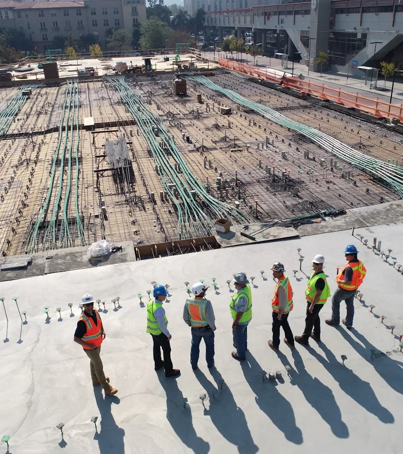 CCD21 Engineers and Site Manager reviewing blueprints on construction site